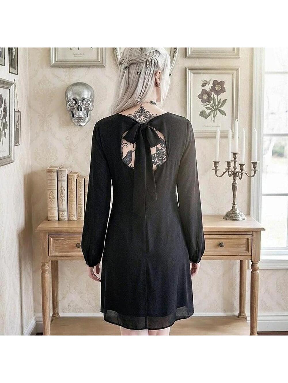 Black gothic dress with open back and bow detail. Size: 10 127